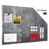 A metallic magnetic board with a concrete texture, featuring various accessories like magnets, markers, and a photo. Anteprima dell’immagine prodotto