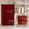 A perfume bottle and its box are displayed on a light-colored surface, with a blurred background of shelves. Anteprima dell’immagine prodotto