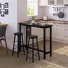 A modern kitchen with a black bar table and stools, set up for a meal. Náhľad obrázku produktu