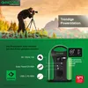 A photographer is taking a picture in a mountainous landscape, with a portable power station and its charging options displayed below. Produktbild-Vorschau