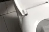 A close-up view of a white toilet lid and hinge mechanism, with tiled flooring visible in the background. Náhled obrázku produktu