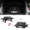 A collage of images showing a portable gas grill in different contexts, including inside a car trunk and with dimensions indicated. Produktbild-Vorschau