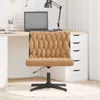 A beige office chair is placed in a home office setting, with a desk, laptop, and lamp visible. Podgląd zdjęcia produktu