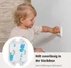 A baby is reaching for an electrical outlet that has a safety cover installed. Anteprima dell’immagine prodotto