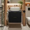 A modern bathroom vanity with a vessel sink and a plant. Anteprima dell’immagine prodotto