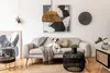 A dog is lying on a sofa in a living room with a coffee table and a side table. Produktbild-Vorschau