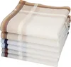 A stack of folded handkerchiefs with different colored borders. Produktbild-Vorschau