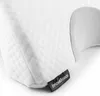 Close-up of a white quilted pillow with a gray inner section and a black tag. Podgląd zdjęcia produktu