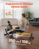 A man is using a rowing machine in a well-lit room. Produktbild-Vorschau