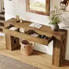 A wooden console table with drawers open, displaying items inside, in a home entryway with a mirror and a lamp. Podgląd zdjęcia produktu