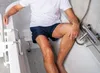 A person sitting on a bath stool in a bathtub. Produktbild-Vorschau