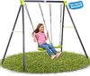 A young girl is swinging on a swing set in a grassy area. Produktbild-Vorschau