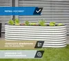 A silver corrugated metal raised garden bed filled with plants, set on a green lawn in front of a building with horizontal blinds. Produktbild-Vorschau