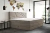 A bedroom scene featuring a beige boxspring bed with a modern headboard, a world map wall decoration, and ambient lighting. Voir les images du produit