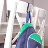 A backpack hanging on the back of a white chair. Podgląd zdjęcia produktu
