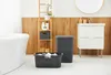 A clean and organized bathroom setting with laundry items. Produktbild-Vorschau
