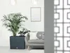 A modern living room with a grey sofa, plants in a planter, and a framed picture on the wall. Náhľad obrázku produktu