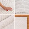 A collage of four images showing different views of a white rug with a geometric pattern. One image shows a hand touching the rug, another shows a close-up of the texture, a third shows the rug rolled up, and the fourth shows a corner of the rug on a woode Anteprima dell’immagine prodotto