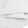 A close-up view of a white duvet or comforter, folded to show its texture and layers. Podgląd zdjęcia produktu