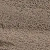A close-up view of a shaggy, high-pile rug. Voir les images du produit