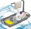 A dish rack with cleaning supplies and a towel, with water splashes. Produktbild-Vorschau