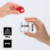 Hands holding a small glass jar and its red lid, with dimensions and weight indicated. Podgląd zdjęcia produktu