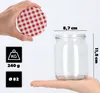 A hand holding a red and white checkered lid above a clear glass jar, with dimensions and weight information displayed. Anteprima dell’immagine prodotto
