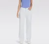 A woman is shown from the waist down, wearing white pants and a blue top. Produktbild-Vorschau