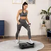 A woman is exercising on a vibration plate with resistance bands in a room. Náhľad obrázku produktu