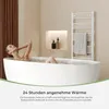 A woman relaxing in a bathtub with a towel warmer in the background. Produktbild-Vorschau