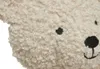 A close-up of a fluffy teddy bear's face. Produktbild-Vorschau