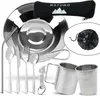 A collection of camping tableware and cutlery, including plates, cups, and utensils, arranged on a white background. Produktbild-Vorschau
