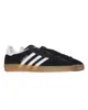 A pair of black Adidas Gazelle sneakers with white stripes and a tan sole, presented on a white background. Produktbild-Vorschau