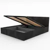 A dark gray upholstered bed frame with the mattress support raised, revealing storage space underneath. Produktbild-Vorschau