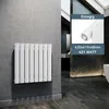 A white panel radiator mounted on a gray wall in a modern bathroom setting. Podgląd zdjęcia produktu