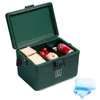 A green cooler box is open, showing food and a drink inside. There are also ice packs next to it. Produktbild-Vorschau