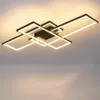A modern, geometric ceiling light fixture with multiple rectangular frames illuminated by LED lights, mounted on a ceiling. Produktbild-Vorschau