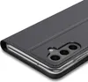 A close-up, angled view of a black flip case for a smartphone, showing the camera cutout and the edge of the phone. Náhľad obrázku produktu