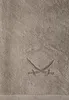 A close-up view of a taupe towel with an embroidered design of two crossed sabers. Produktbild-Vorschau