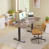 A modern home office setup featuring a standing desk, computer monitor, laptop, and an ergonomic chair. Produktbild-Vorschau