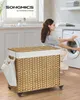 A woman is loading laundry into a washing machine next to a wicker laundry basket. Produktbild-Vorschau
