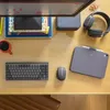 A desk setup with a computer monitor, keyboard, mouse, headphones, tablet, and a mug of coffee. Náhled obrázku produktu