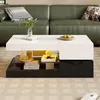 A modern living room setting with a green leather sofa and a white and black high-gloss coffee table. Anteprima dell’immagine prodotto