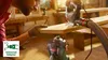 A person is using a jigsaw with a vacuum hose attached in a workshop. Voir les images du produit