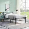 A bedroom with a bed, nightstand, and a window. Voir les images du produit
