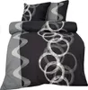 A bedding set with a black background and a gray wavy stripe pattern on the left side and a pattern of white circles on the right side. Two pillows are stacked on top of the duvet. Produktbild-Vorschau