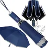 A dark blue automatic folding umbrella is displayed in various states of use and storage, with water splashes indicating its function. Náhled obrázku produktu
