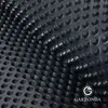A close-up of a black drainage mat with raised bumps, showing its texture and pattern. Produktbild-Vorschau