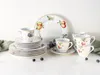 A collection of porcelain dinnerware with fruit and berry motifs, arranged on a white surface with a light gray background. Náhľad obrázku produktu