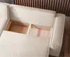 A close-up view of the interior storage compartment of a cream-colored sofa. Produktbild-Vorschau